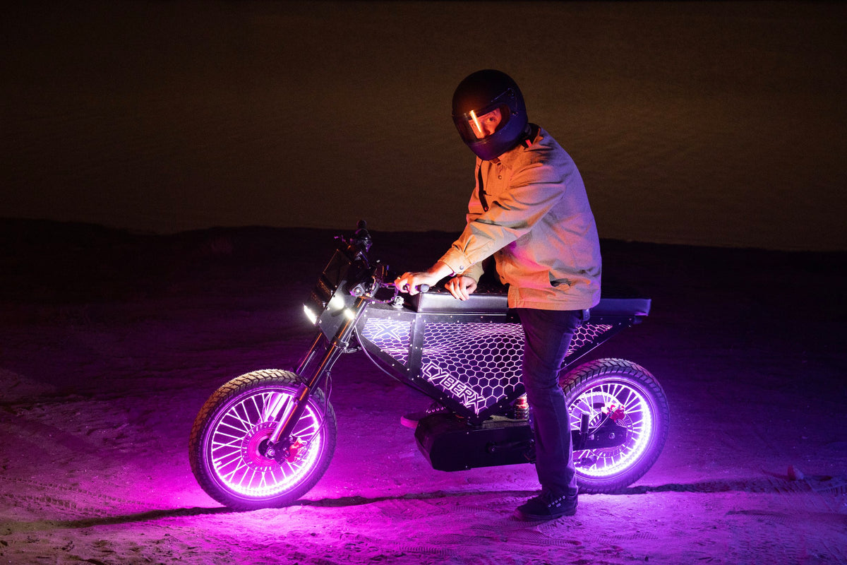 Xion CyberX e-bike with purple LED lighting and rider at night