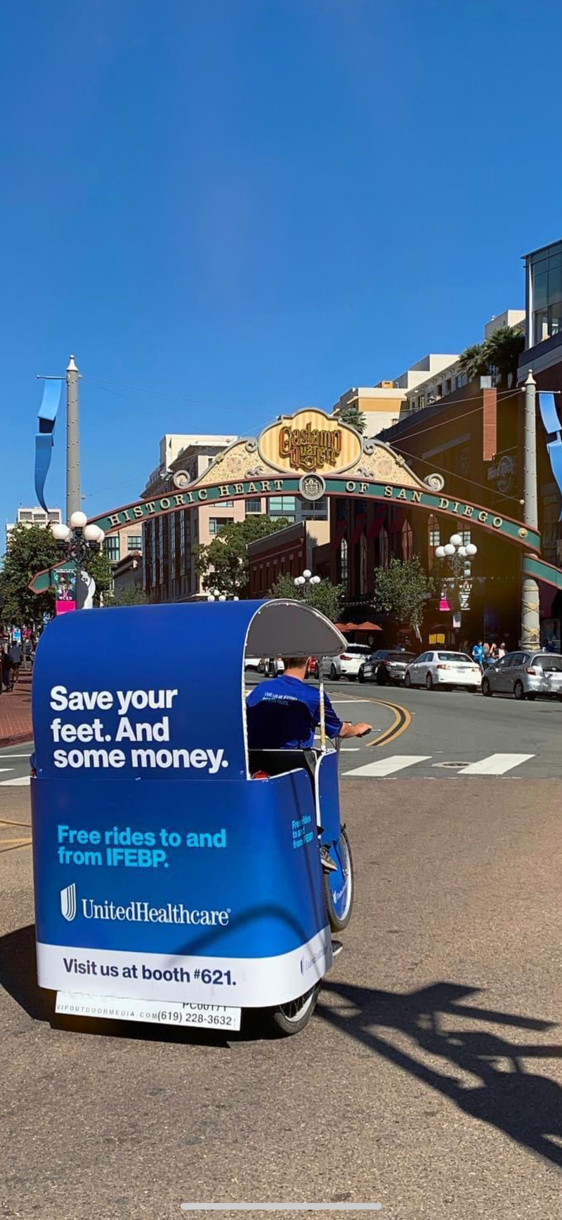 Xion electric pedicab with blue sponsor wrap in San Diego's Gaslamp Quarter